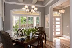 a dining room table with plates and flowers on it