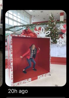 a woman in a red and white box surrounded by christmas decorations