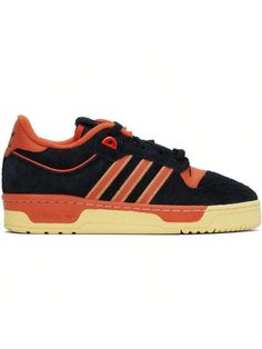 adidas Originals 
Black & Orange Rivalry 86 Low Sneakers 
Low-top brushed suede and buffed leather sneakers in black and orange. 
. Perforated detailing at toe 
. Lace-up closure 
. Logo patch at padded tongue 
. Padded collar 
. Topstitching and signature stripes at sides 
. Logo embossed at heel tab 
. Terry cloth lining 
. Logo embossed at textured rubber midsole 
. Treaded rubber sole 
Supplier color: Core black/Preloved red/Easy yellow 
Upper: leather. Sole: rubber. 
Made in Viet Nam. 
2417 High-top Adidas Suede Skate Shoes, Adidas High-top Suede Skate Shoes, Orange Adidas Logo Sneakers For Streetwear, Orange Adidas Sneakers For Streetwear, Orange Skate Shoes With Contrast Sole For Streetwear, Black Suede Adidas Sneakers, Orange High-top Skate Shoes With Contrast Sole, Casual Orange Adidas Sneakers, Orange Low-top Skate Shoes With Contrast Sole