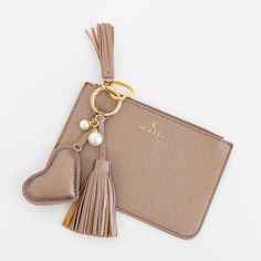 a keychain with a heart shaped tassel hanging from it's side