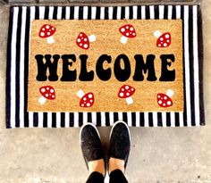 a person standing in front of a welcome mat