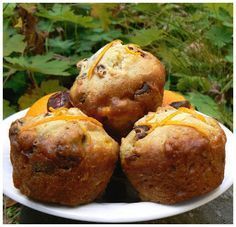 a white plate topped with muffins covered in cheese