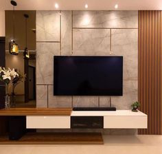 a living room with a large flat screen tv mounted on the side of it's wall