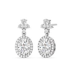 Elevate your style to new heights with our Large Oval with Halo Drop Earrings. These magnificent earrings are not just jewelry; they are a masterpiece that defines luxury and sophistication. With a combination of large oval diamonds, a stunning halo, and a diamond cluster top featuring a blend of pear and round-shaped diamonds, these earrings are a captivating statement of your unique taste and unmatched elegance. Exquisite Oval Diamond Earrings With Accents, Elegant Bridal Earrings With Halo Setting Diamond, Elegant Diamond Bridal Earrings With Halo Setting, Exquisite Oval Brilliant Cut Diamond Earrings, Exquisite Oval Diamond Earrings With Brilliant Cut, Luxury Oval Bridal Earrings With Prong Setting, Luxury Oval White Gold Bridal Earrings, Luxury Oval Bridal Earrings For Formal Occasions, Oval Diamond Accented Bridal Earrings