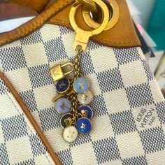 Authentic Louis Vuitton Bag Chem/Kettle Chain. Blues, Cream, And Gold Charms. Perfectly Complements The Damier Azure Line. It Was Used To Decorate My Louis Vuitton Damier Azure Gallleria. It Is In Very Good Condition. A Tiny Bit Of Tarnish On The Main Ring. Can Be Buffed Of So Desired. Bag Is For Sale On Another Listing. Louis Vuitton Keychain, Louis Vuitton Blue, Authentic Louis Vuitton Bags, Gold Charms, Keychain Bag, Louis Vuitton Accessories, Vuitton Bag, Key Card Holder, Cream And Gold