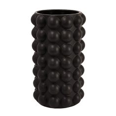 a black vase with many balls in it