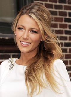 a black and white photo of a woman with long blonde hair wearing a tiara