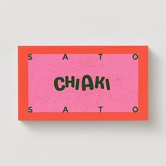 an orange and pink sticker with the word chaki on it