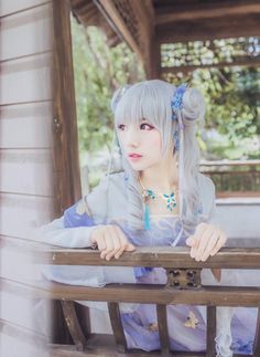 a woman with grey hair sitting on a bench