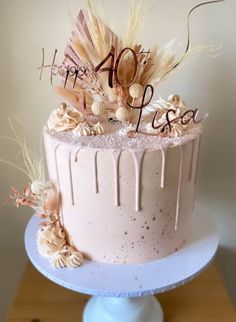 a birthday cake decorated with feathers and flowers