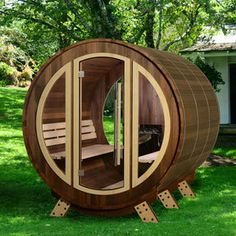 a wooden sauna in the grass near a house