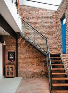 a brick building with stairs leading up to the second floor