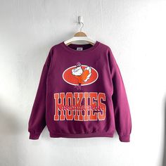 Vintage 90s Virginia Tech Hokies Crewneck Sweatshirt Team Sportswear  Condition : Used vintage Good conditions Details : stains (Look at the picture) Please Let me know if you have any      questions or More Photo Detail Brand : TNT Made in : USA  Measurement Size On Tag : XL Pit to pit : 24 inches Length : 27 inches Material : Cotton Polyester Color : Red (burgundy)  *Please keep in mind that our items are vintage so they may show some signs of wear and tear *Please read everything before buying  No Cancel  No Refund  No Return  payment Accept PayPal only. Please give us your phone number together with address after you purchasing.( No P.O Box  shipping to worldwide Item will shipped in 1-3 days after payment. ( remote area The shipping cost is higher) Thank you :) 90s Style Sweatshirt For Game Day, 90s Style Sweatshirt For Fall Sports Events, Team-colored Throwback Cotton Sweatshirt, 90s Crew Neck Sports Sweatshirt, Red Long Sleeve Collegiate T-shirt, Virginia Tech Sweatshirt, Collegiate Long Sleeve Red T-shirt, Virginia Tech Hokies, Virginia Tech