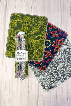 three placemats with different designs on them sitting next to each other and one has a tag that says garden's favorite