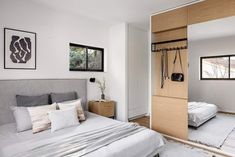 a bedroom with white walls and wooden doors