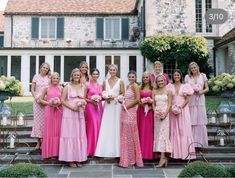 a group of women standing next to each other in front of a building