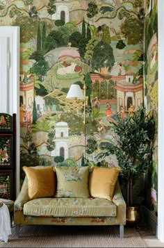 a living room with a couch and wallpaper on the walls in front of it