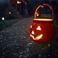 a pumpkin lantern is lit up in the dark