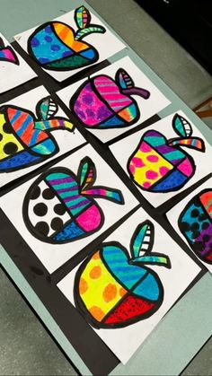 several colorful stickers with different shapes and sizes on them sitting on top of a table