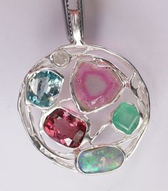 Tourmaline opal Emerald and diamond as a pendant Details: Pendant 36 x 28 x 6 mm Opal, 10 x 6 x 3 mm, multicolor, Australia tourmaline 13 x 11  x 4 mm red tourmaline 9 x 7 x 5 mm Aquamarine 8 x 7 x 5 mm Emerald 6 x 5.5 x 4 mm diamond, 3.5 mm, I, white 925 silver, soldered Multi-stone Opal Fine Jewelry, Luxury Multi-stone Pendant Gemstones, Opal Multi-stone Pendant Necklace, Luxury Multi-stone Opal Jewelry, Red Tourmaline, Oval Cabochon Opal Multi-stone Jewelry, Emerald Diamond, Aquamarine, Diamond Pendant