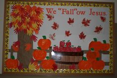 a bulletin board with pumpkins and fall leaves in the background that says we fallow jesus