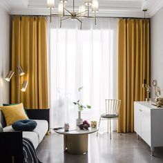 a living room filled with furniture and curtains