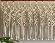 the macrame wall hanging is made with white yarn