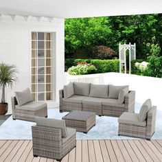 an outdoor living room with wicker furniture