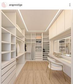 an image of a walk in closet with white shelves and drawers on the wall,