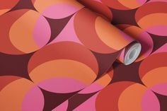 an orange, pink and brown wallpaper with circles in the center on it's surface