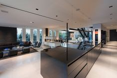 Light filled chic & modern LA open plan loft home with custom design & furnishings. Black Kitchen Bar