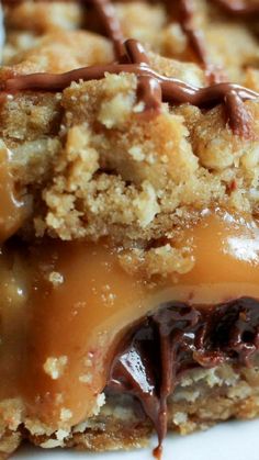 a close up of a dessert on a plate with chocolate drizzled over it