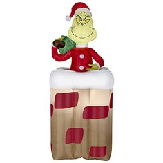 an inflatable christmas decoration with a santa hat and grino on it's head