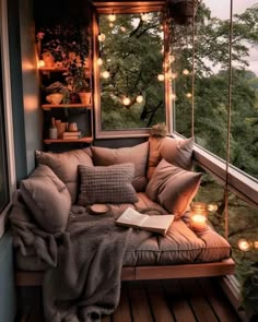 a couch sitting on top of a wooden floor next to a window covered in lights