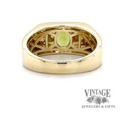 This ring features a bezel-set oval Peridot weighing approximately 1.3 carats, accented by ten 1.3mm round diamonds. 10k yellow gold size 11 7.9 grams Yellow Gold Wide Band Jewelry With Bezel Setting, Yellow Gold Jewelry With Bezel Setting In Wide Band, Yellow Gold Jewelry With Gemstone In Wide Band, Classic Jewelry With Bezel Setting And Wide Band, Yellow Gold Wide Band Jewelry With Gemstone, Modern 14k Gold Collectible Jewelry, Collectible Yellow Gold Jewelry With Accent Stones, Collectible Modern 14k Gold Jewelry, Gold Oval Signet Ring With Accent Stones