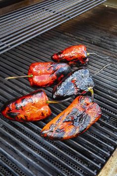 several peppers are cooking on the grill