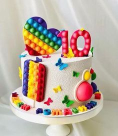 a birthday cake with the number ten on it and decorations made out of legos