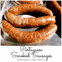 some sausages are sitting on a metal tray with the words portuguese smoked sausages