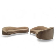 two curved couches sitting next to each other