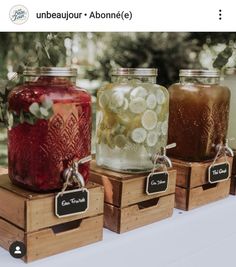 three jars filled with different types of food sitting on top of wooden crates next to each other