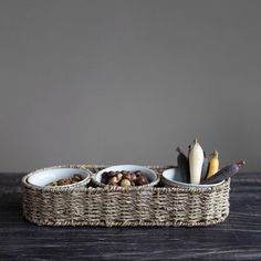 two bowls filled with food sitting on top of a wooden table