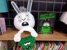 a book shelf filled with books and stuffed animals