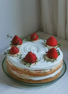 a cake with white frosting and strawberries on top