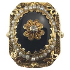 10 Karat Yellow Gold Onyx and Seed Pearl Ring Size 7 This elegant ring features one oval onyx stone (14 mm x 12.5 mm), 36 seed pearls and one clear stone set in meticulously detailed 10K yellow gold. Top of ring measures 24 mm x 19 mm. Shank: 2.5 mm. Tested 10K gold. Ring Size: 7 Weight:  7.5 dwt. / 11.7 gr. Very good condition, professionally polished. Will come packaged in a gift box or pouch (when possible) and will be shipped U.S. Priority Mail Insured. DV081924/17KCS Pearl Cocktail Ring, Art Deco Sapphire Ring, Oval Sapphire Ring, Sapphire Eternity Ring, Seed Pearl Ring, Contemporary Engagement Rings, Gold Pearl Ring, Diamond Heart Ring, Yellow Gold Diamond Ring