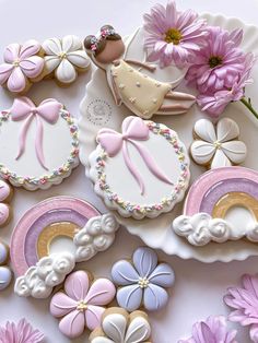 decorated cookies and flowers on a plate