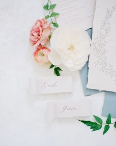 wedding stationery with flowers and leaves on the table