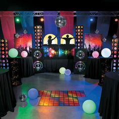 a dance floor with disco balls and lights on the sides, surrounded by black tablecloths