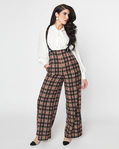 These awesome 1930s style pants are a must-have! They come in a fantastic black and burgundy plaid woven fabric, with an incredible high waist that is cinched with a back zipper and adjustable suspender straps for secure wear. Plus, they have side pockets and come in sizes XS-5X while supplies last - don't miss out on this amazing opportunity! This plus size pant is ready for anything, from casual outfits to going out ensembles Unique Vintage Unique Vintage Black & Burgundy Plaid High Waist Suspender Pants | Black & Burgundy Plaid | Pants | Materials & Care Instructions: ['100% Polyester', 'Hand wash', 'Imported'] Uv Clothing, 1930s Style, Pin Up Outfits, Suspender Pants, 1930s Fashion, Plus Size Pants, Vintage Pinup, Plaid Pants, 50s Fashion