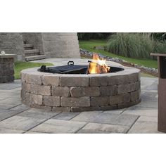 a fire pit sitting on top of a stone patio