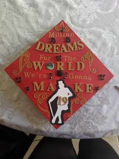 a red graduation cap that says, million dreams for the world we're going to make